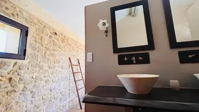 a bathroom with a sink and a mirror on a wall at Le Mas de Bonnety - Magnifique mas 12 personnes au Pied du Mont Ventoux in Saint-Pierre-de-Vassols
