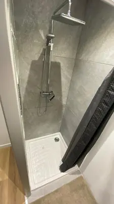 a shower stall in a bathroom with a glass door at la chambrette in Lincel
