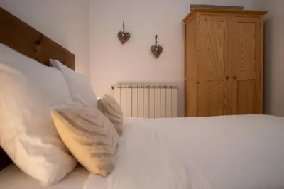 a bedroom with a bed with white sheets and pillows at Ô Coeur Des Ocres in Roussillon