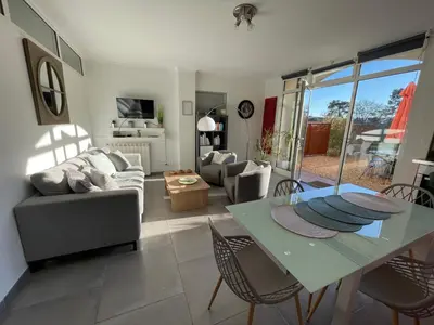 a living room with a table and a couch at Ô Coeur Des Ocres in Roussillon