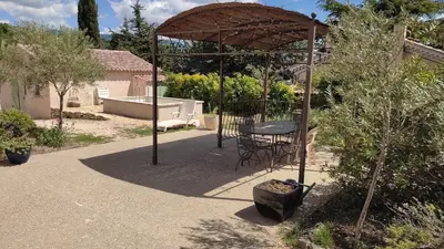 a gazebo with a table in a garden at Location au cœur du Luberon 2 personnes in Saint-Saturnin-les-Apt