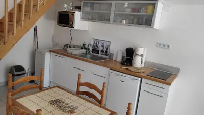 a kitchen with a counter and a sink and a table at Location au cœur du Luberon 2 personnes in Saint-Saturnin-les-Apt