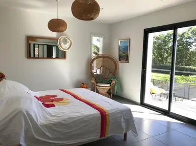 a bedroom with a bed and a large window at Magnifique villa avec piscine Mt Ventoux Provence in Carpentras