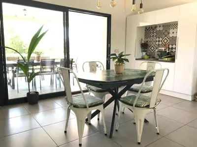 a dining room with a table and chairs in a room at Magnifique villa avec piscine Mt Ventoux Provence in Carpentras