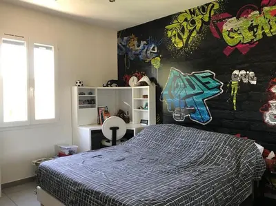 a bedroom with a bed with graffiti on the wall at Magnifique villa avec piscine Mt Ventoux Provence in Carpentras