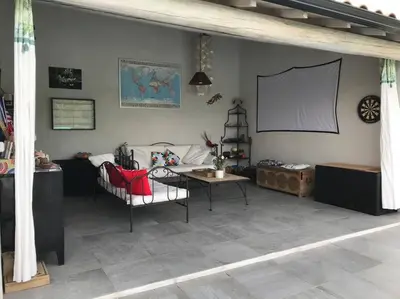 a living room with a couch and a projection screen at Magnifique villa avec piscine Mt Ventoux Provence in Carpentras
