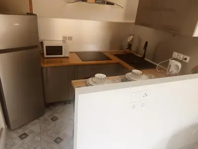 a small kitchen with a refrigerator and a microwave at Studio Zen Miramas in Miramas