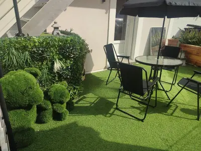 a teddy bear sitting next to a table and chairs at Studio Zen Miramas in Miramas