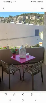 a pink table with two chairs and a table with at En Provence chez Valérie in Cavaillon