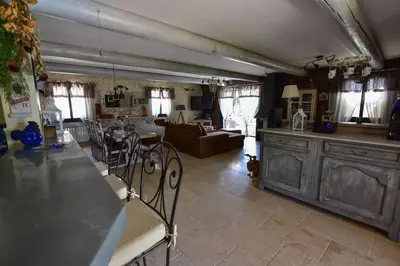 a kitchen and living room with a table and chairs at Villa le 62 Cazan in Vernègues