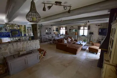 a large living room with a couch and a table at Villa le 62 Cazan in Vernègues