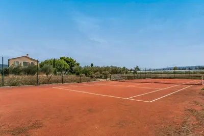 a tennis court with a net on top of it at Les Deux Mas in Lagnes