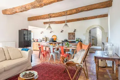 a living room with a couch and a table at Maison Sebastien in Saint-Michel-lʼObservatoire