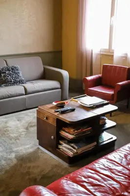 a living room with a couch and a coffee table at Une pause en Provence au Village des antiquaires de la Gare in LʼIsle-sur-la-Sorgue