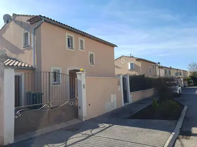 a house with a gate and a fence at Maison en Provence avec jacuzzi in Peyrolles-en-Provence