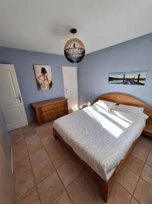 a bedroom with a bed and a blue wall at Maison en Provence avec jacuzzi in Peyrolles-en-Provence