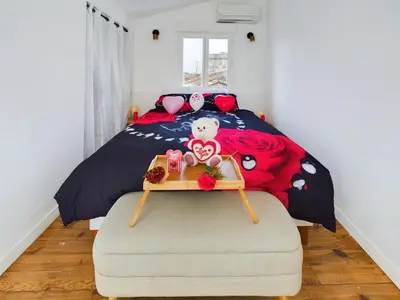 a bedroom with a bed with a teddy bear on it at Pic love, 2 personnes jacuzzi in Châteaurenard