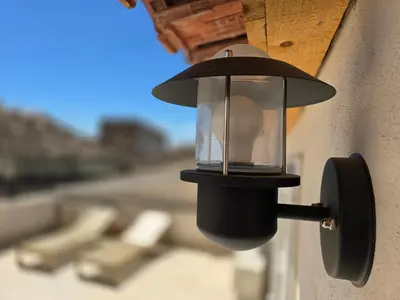 a light on the side of a building at Pic love, 2 personnes jacuzzi in Châteaurenard