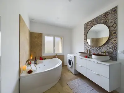a white bathroom with a tub and a washing machine at Pic love, 2 personnes jacuzzi in Châteaurenard
