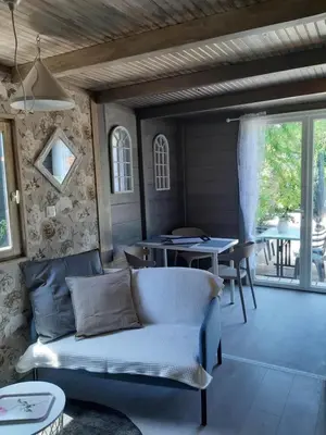 a kitchen with a table and a white door at Camping 4 étoiles - Piscine - eehf0d in Noves