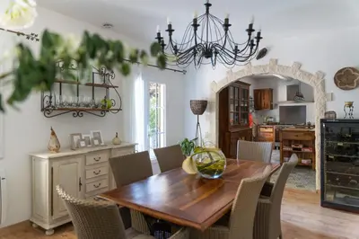 a dining room with a wooden table and chairs at Provencal bastide with heated pool near Alpilles and Luberon in Vernègues