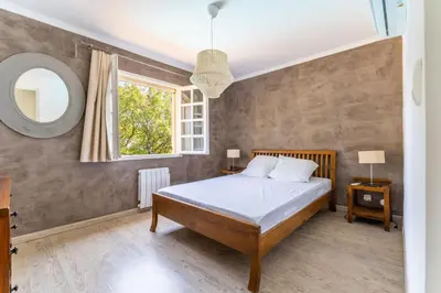 a bedroom with a bed and a window and a mirror at Provencal bastide with heated pool near Alpilles and Luberon in Vernègues