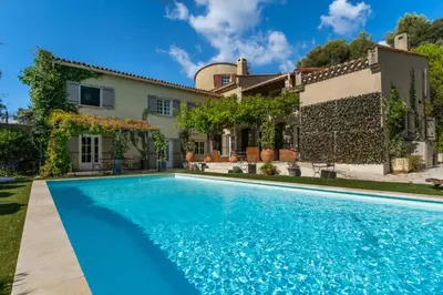 a house with a swimming pool in front of a house at Provencal bastide with heated pool near Alpilles and Luberon in Vernègues