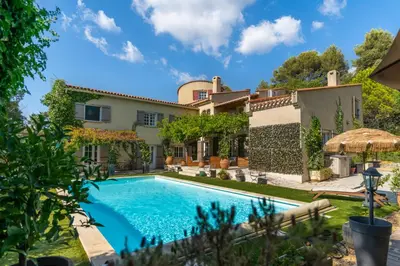 an exterior view of a house with a swimming pool at Provencal bastide with heated pool near Alpilles and Luberon in Vernègues