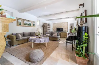a living room with a couch and a table at Provencal bastide with heated pool near Alpilles and Luberon in Vernègues