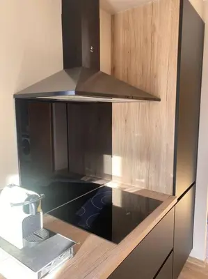 a kitchen with a hood and a stove top oven at Gîte Un air de Provence in Eyguières