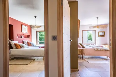 a bedroom with two beds and a living room at KM2 in Bédoin