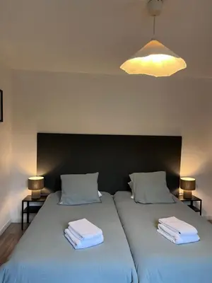 two beds with towels on top of them in a room at B&B Lily et Paul in Bédoin
