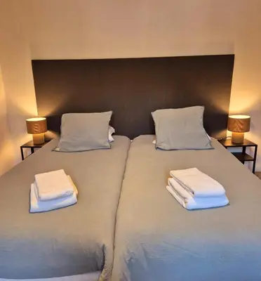 a large bed with two towels on top of it at B&B Lily et Paul in Bédoin