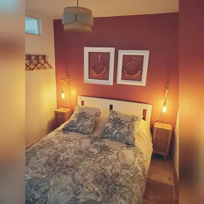 a bedroom with a bed and two pictures on the wall at Harmonie in Monteux