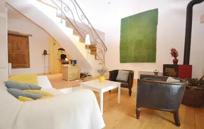 a living room with a couch and a table at 1 Bedroom Lovely Home In Viens in Viens