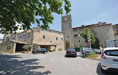 a large stone building with cars parked on the street at 1 Bedroom Lovely Home In Viens in Viens