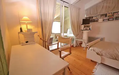 a bedroom with a bed and a table with a lamp at 1 Bedroom Lovely Home In Viens in Viens