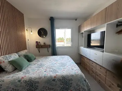 a bedroom with a bed and a dresser with a television at Charmant studio le clos d'Aix parking privé gratuit et piscine in Aix-en-Provence