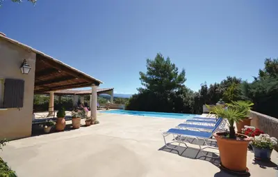 a villa with a swimming pool and a patio at Awesome Home In Joucas With Kitchen in Joucas