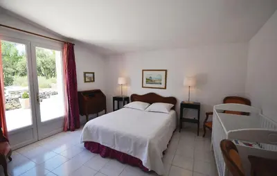 a bedroom with a bed and a large window at Awesome Home In Joucas With Kitchen in Joucas