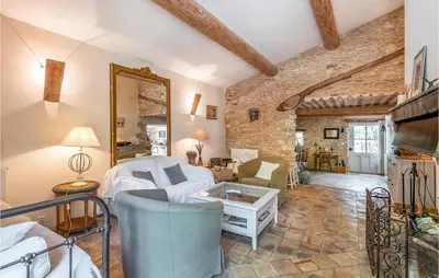 a living room with a white couch and a mirror at Belle Maison À Lacoste in Lacoste