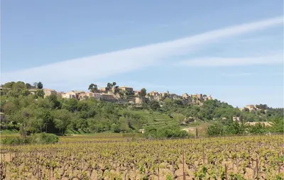 a vineyard with a house on top of a hill at Belle Maison À Lacoste in Lacoste