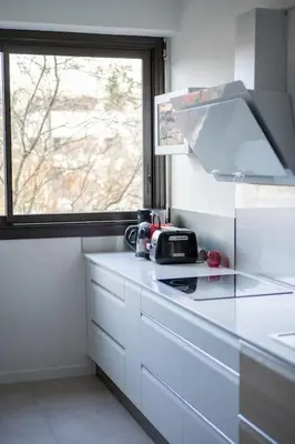 a kitchen with a counter top with a window at T3 Centre ville Aix-en-Provence in Aix-en-Provence
