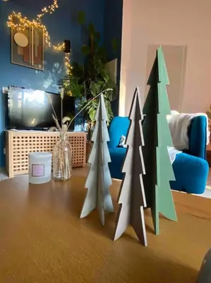 three paper christmas trees on a table in a living room at Charmante dépendance avec piscine en Provence in Le Puy-Sainte-Réparade