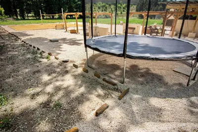 a playground with a trampoline on the ground at Maison conviviale avec jardin proche Avignon + piscine partagée in Avignon