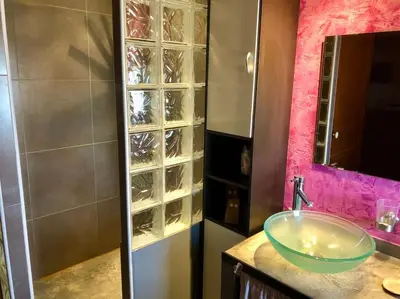 a bathroom with a sink and a glass shower at Superbe mas proche centre-ville in Salon-de-Provence