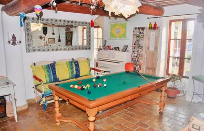 a living room with a pool table and a couch at Superbe mas proche centre-ville in Salon-de-Provence