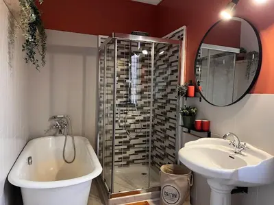a bathroom with a glass shower and a sink at Le l'islois- Park&Piscine in LʼIsle-sur-la-Sorgue