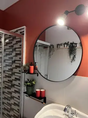 a bathroom with a mirror and a sink at Le l'islois- Park&Piscine in LʼIsle-sur-la-Sorgue