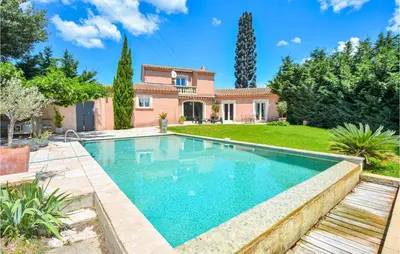 a swimming pool in a yard with a house at Nice Home In Eyguieres With Wifi in Eyguières